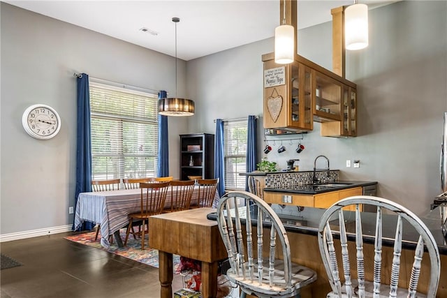29 Kentallen Ln, Bella Vista, AR 72715 - kitchen with glass insert cabinets, dark countertops, and brown cabinetry