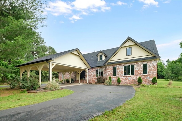 605 SW O St, Bentonville, AR 72712 - view of front of house featuring driveway, a front yard, brick siding, and a carport