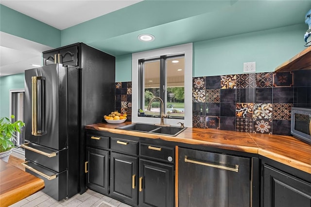 605 SW O St, Bentonville, AR 72712 - kitchen with a sink, appliances with stainless steel finishes, decorative backsplash, recessed lighting, and dark cabinetry