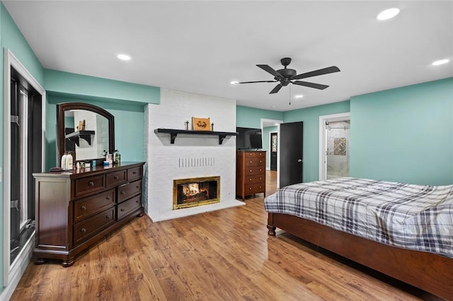 605 SW O St, Bentonville, AR 72712 - bedroom featuring wood finished floors, a fireplace, recessed lighting, and ceiling fan