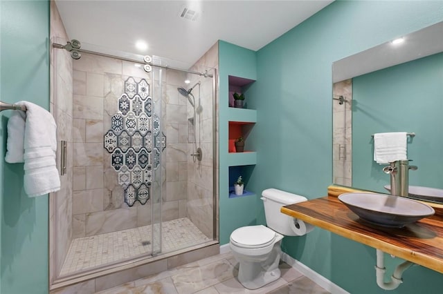 605 SW O St, Bentonville, AR 72712 - full bath with toilet, a sink, a shower stall, and baseboards