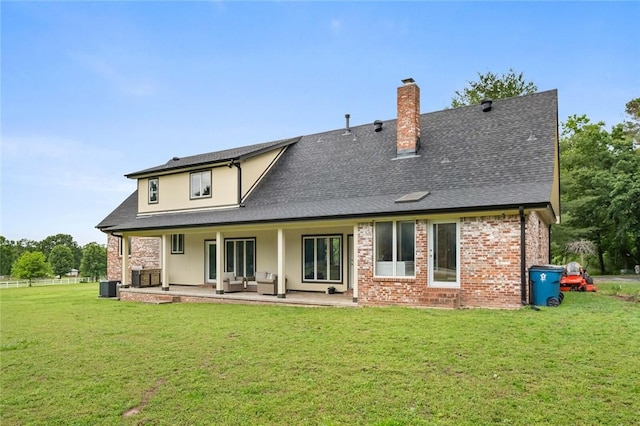 605 SW O St, Bentonville, AR 72712 - back of property with a chimney, a yard, cooling unit, and a shingled roof
