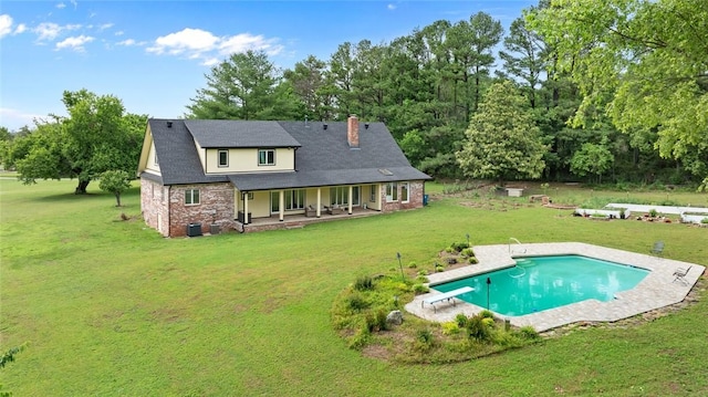 605 SW O St, Bentonville, AR 72712 - rear view of property with a chimney, a lawn, covered porch, and an outdoor pool