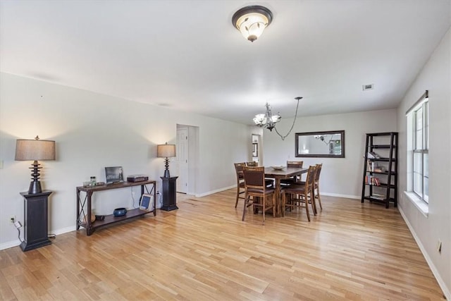 17171 Kincheloe Rd, Siloam Springs, AR 72761 - dining space with light wood-type flooring, a chandelier, and baseboards