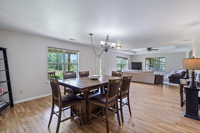 17171 Kincheloe Rd, Siloam Springs, AR 72761 - dining area featuring a chandelier, plenty of natural light, light wood-type flooring, and ceiling fan