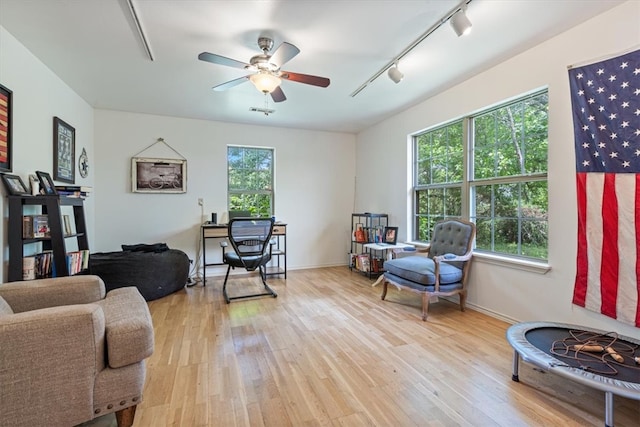 17171 Kincheloe Rd, Siloam Springs, AR 72761 - living area with rail lighting, light wood-style flooring, a ceiling fan, and baseboards