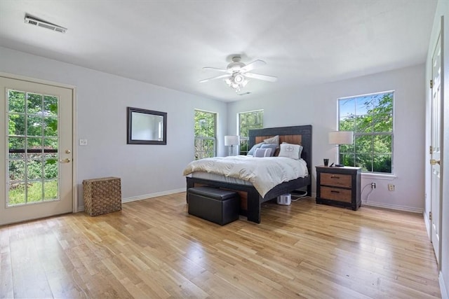17171 Kincheloe Rd, Siloam Springs, AR 72761 - bedroom featuring multiple windows, light wood-style flooring, and baseboards