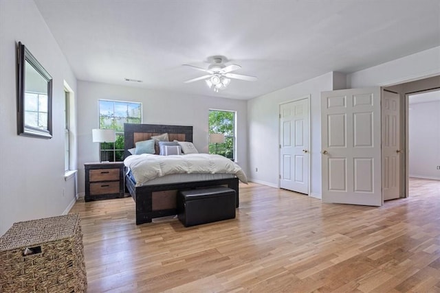17171 Kincheloe Rd, Siloam Springs, AR 72761 - bedroom with light wood-type flooring, baseboards, and ceiling fan