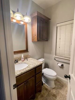 10211 Lydia Ln, Danville, AR 72833 - bathroom featuring vanity, toilet, and baseboards