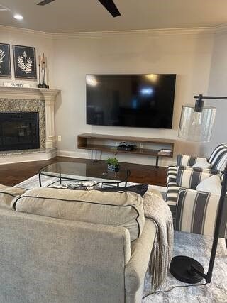10211 Lydia Ln, Danville, AR 72833 - living area featuring crown molding, a ceiling fan, a fireplace, and baseboards