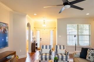 10211 Lydia Ln, Danville, AR 72833 - living area with baseboards, ornamental molding, wood finished floors, arched walkways, and a ceiling fan