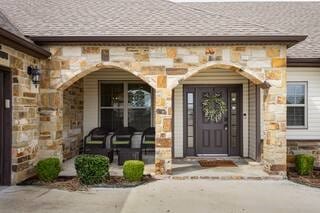 10211 Lydia Ln, Danville, AR 72833 - property entrance with stone siding and covered porch