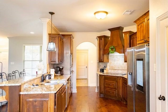 10211 Lydia Ln, Danville, AR 72833 - kitchen featuring appliances with stainless steel finishes, a sink, a peninsula, custom range hood, and light stone countertops