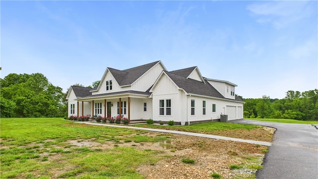 14290 Osage Creek Rd, Springdale, AR 72762 - view of front of home featuring driveway, a front yard, a porch, a shingled roof, and central air condition unit