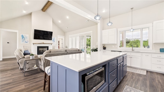 14290 Osage Creek Rd, Springdale, AR 72762 - kitchen featuring stainless steel microwave, beam ceiling, dark wood-type flooring, a fireplace, and white cabinetry