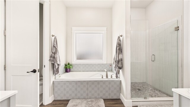 14290 Osage Creek Rd, Springdale, AR 72762 - bathroom with a garden tub, a stall shower, wood finished floors, and vanity