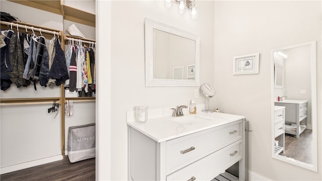 14290 Osage Creek Rd, Springdale, AR 72762 - bathroom with wood finished floors, vanity, a walk in closet, and baseboards