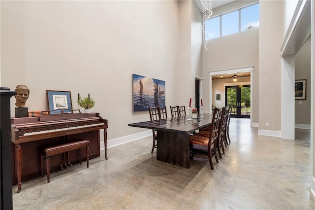 3634 Sugarberry Ln, Springdale, AR 72764 - dining area with concrete floors, baseboards, a towering ceiling, and french doors