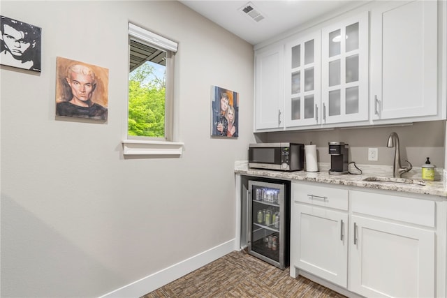 3634 Sugarberry Ln, Springdale, AR 72764 - indoor bar with beverage cooler, stainless steel microwave, and baseboards
