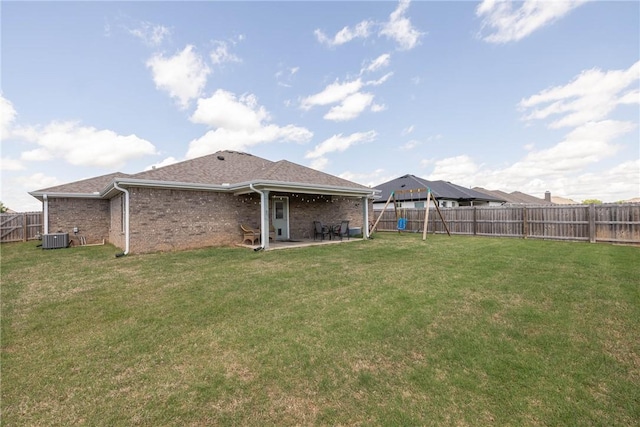 6013 Quinn St, Fayetteville, AR 72704 - back of property featuring central AC, a patio area, brick siding, and roof with shingles