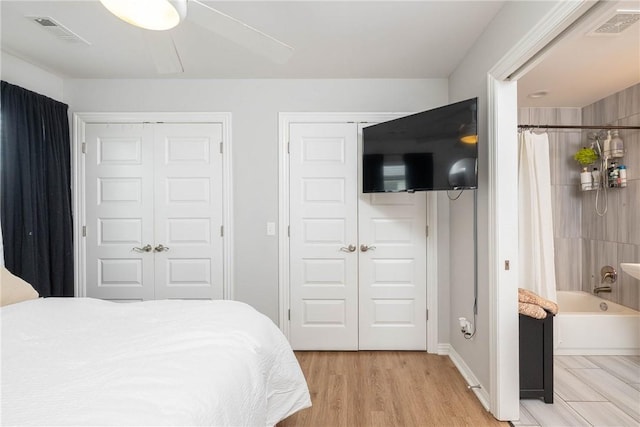 6013 Quinn St, Fayetteville, AR 72704 - bedroom featuring light wood-type flooring and two closets
