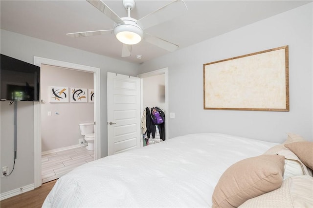 6013 Quinn St, Fayetteville, AR 72704 - bedroom with wood finished floors, baseboards, ensuite bathroom, and ceiling fan