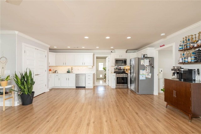 6013 Quinn St, Fayetteville, AR 72704 - kitchen with stainless steel appliances, crown molding, light wood-style floors, white cabinets, and light countertops