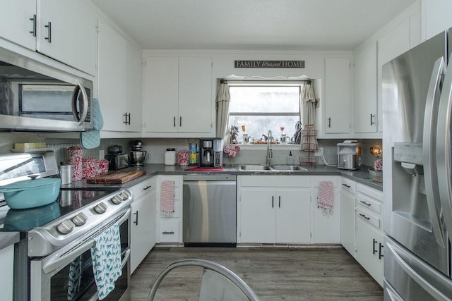 817 Madison 8610, Huntsville, AR 72740 - kitchen with appliances with stainless steel finishes, a sink, white cabinetry, and wood finished floors