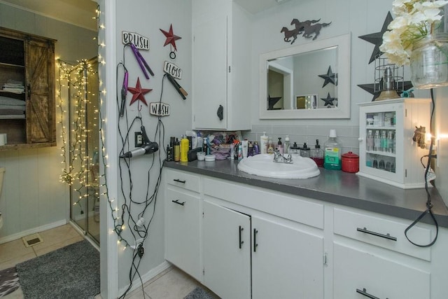 817 Madison 8610, Huntsville, AR 72740 - bathroom featuring tile patterned floors, vanity, and tasteful backsplash