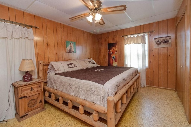 817 Madison 8610, Huntsville, AR 72740 - bedroom featuring wood walls, a paneled ceiling, and a ceiling fan