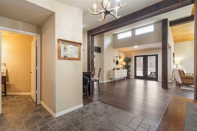 4933 Rocky Ridge Trl, Little Flock, AR 72756 - foyer featuring a chandelier, baseboards, stone tile flooring, and french doors