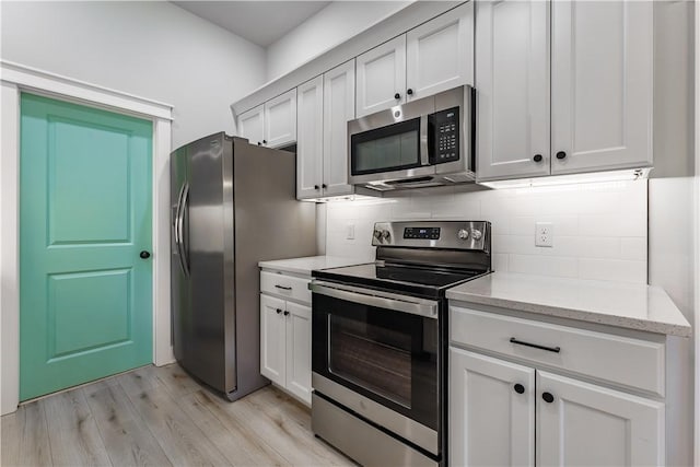 8 Grantham Dr, Bella Vista, AR 72714 - kitchen featuring stainless steel appliances, light wood finished floors, backsplash, and light stone countertops