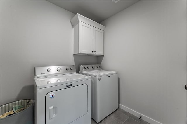 8 Grantham Dr, Bella Vista, AR 72714 - washroom featuring cabinet space, separate washer and dryer, baseboards, and dark tile patterned floors