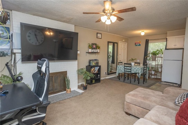 1627 W Hefley St, Fayetteville, AR 72703 - living room featuring a textured ceiling, ceiling fan, carpet flooring, and a brick fireplace