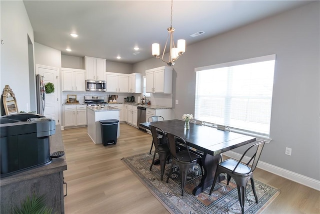 5803 SW Gentle Winds Ave, Bentonville, AR 72713 - dining room with a chandelier, light wood-type flooring, baseboards, and recessed lighting
