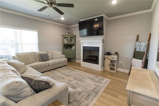 5803 SW Gentle Winds Ave, Bentonville, AR 72713 - living area with ornamental molding, a fireplace, light wood-type flooring, ceiling fan, and baseboards