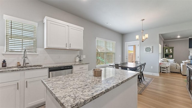 5803 SW Gentle Winds Ave, Bentonville, AR 72713 - kitchen featuring a sink, stainless steel dishwasher, decorative backsplash, light wood finished floors, and white cabinets