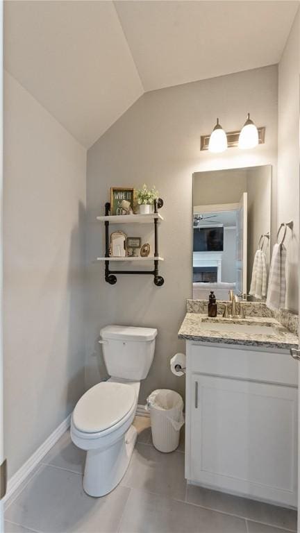5803 SW Gentle Winds Ave, Bentonville, AR 72713 - half bath with vaulted ceiling, toilet, vanity, tile patterned floors, and baseboards