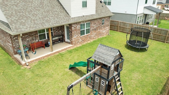 5803 SW Gentle Winds Ave, Bentonville, AR 72713 - view of yard featuring a trampoline and a patio