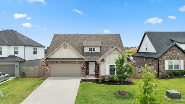 5803 SW Gentle Winds Ave, Bentonville, AR 72713 - view of front facade featuring board and batten siding, concrete driveway, an attached garage, brick siding, and roof with shingles