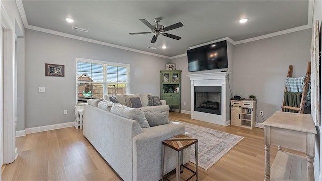 5803 SW Gentle Winds Ave, Bentonville, AR 72713 - living room with ceiling fan, light wood-style flooring, a fireplace, crown molding, and recessed lighting