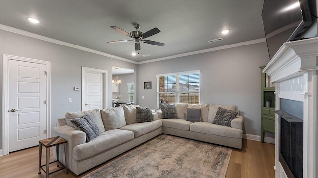 5803 SW Gentle Winds Ave, Bentonville, AR 72713 - living area with ceiling fan, light wood-type flooring, recessed lighting, ornamental molding, and a chandelier