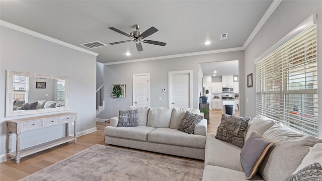 5803 SW Gentle Winds Ave, Bentonville, AR 72713 - living area with light wood finished floors, stairway, recessed lighting, ornamental molding, and a ceiling fan