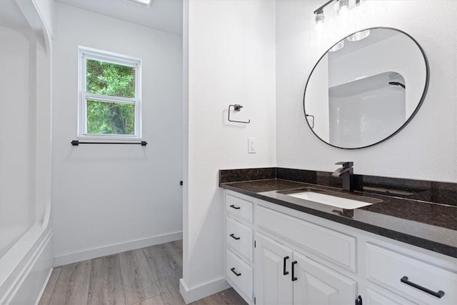 119 Elm St, Centerton, AR 72719 - bathroom with vanity, wood finished floors, and baseboards