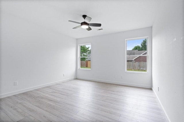 119 Elm St, Centerton, AR 72719 - empty room featuring plenty of natural light, ceiling fan, and light wood-style floors