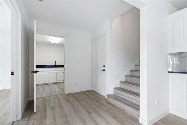 119 Elm St, Centerton, AR 72719 - stairs featuring wood finished floors and baseboards