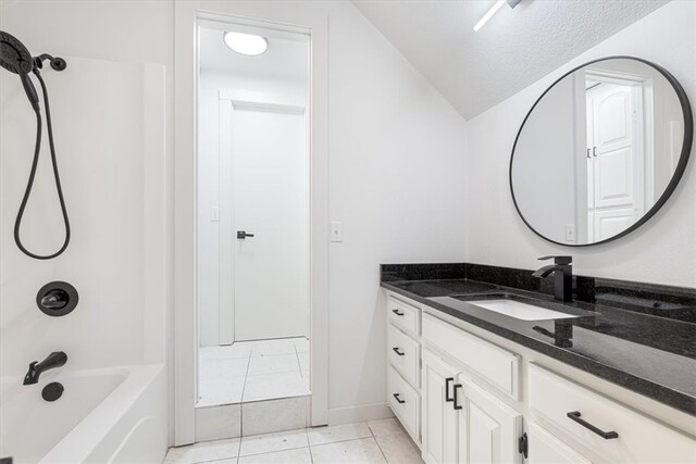119 Elm St, Centerton, AR 72719 - bathroom with vanity, tile patterned flooring, vaulted ceiling, bathtub / shower combination, and a textured ceiling