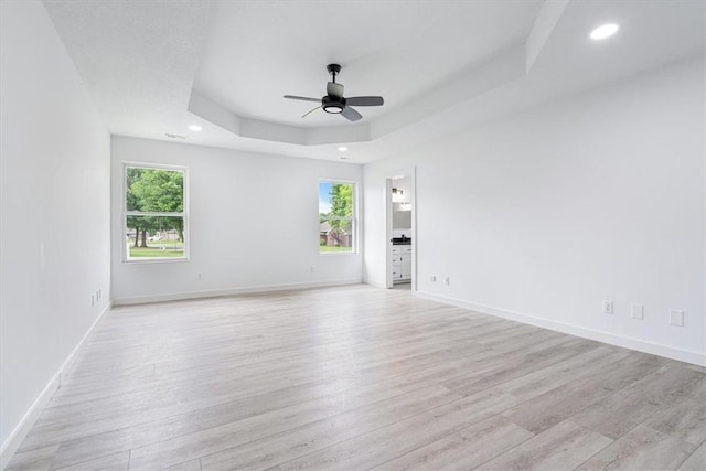 119 Elm St, Centerton, AR 72719 - empty room featuring a ceiling fan, light wood-type flooring, a raised ceiling, recessed lighting, and baseboards
