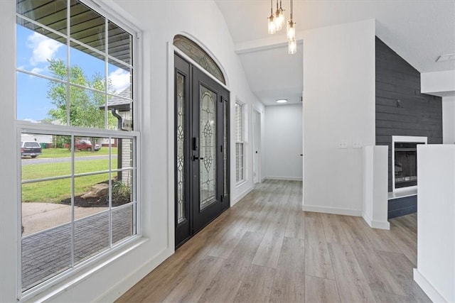 119 Elm St, Centerton, AR 72719 - foyer featuring lofted ceiling, wood finished floors, baseboards, and a fireplace