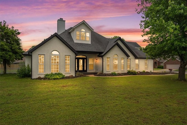119 Elm St, Centerton, AR 72719 - french country style house featuring a chimney, a lawn, and roof with shingles